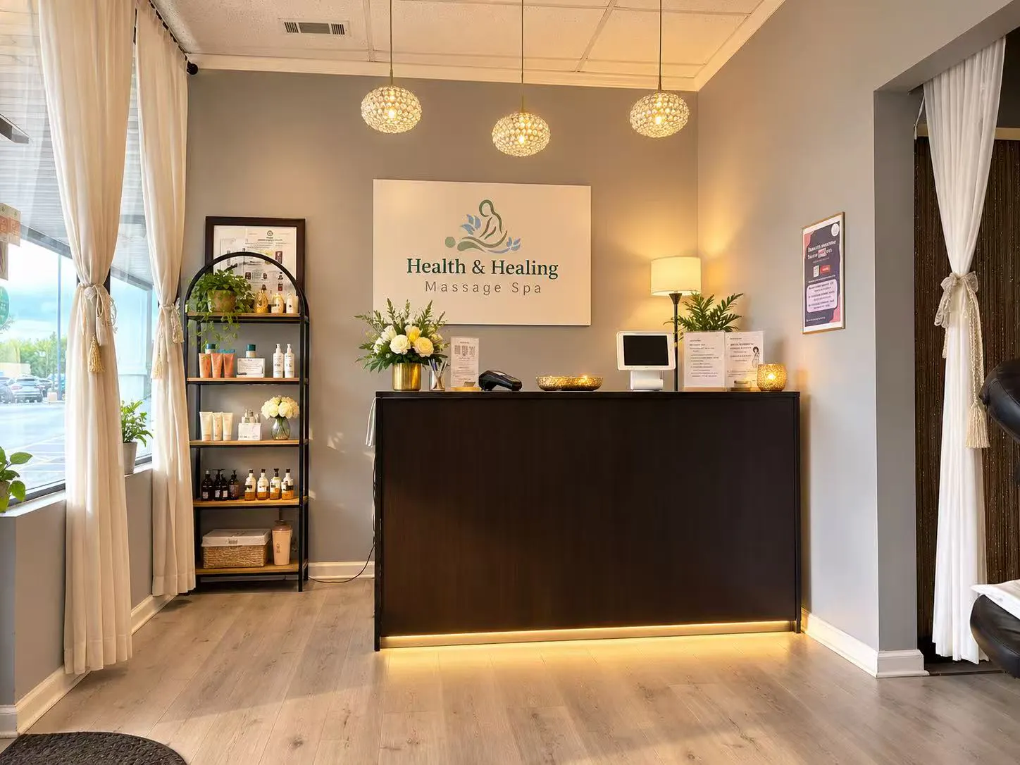 Reception desk beneath the Health & Healing sign, three crystal pendant lights and a product shelf